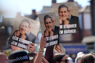 Protesters held signs reading 'Keir Starmer Jew harmer'